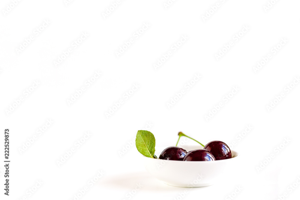 Fototapeta premium ripe cherries on a white background