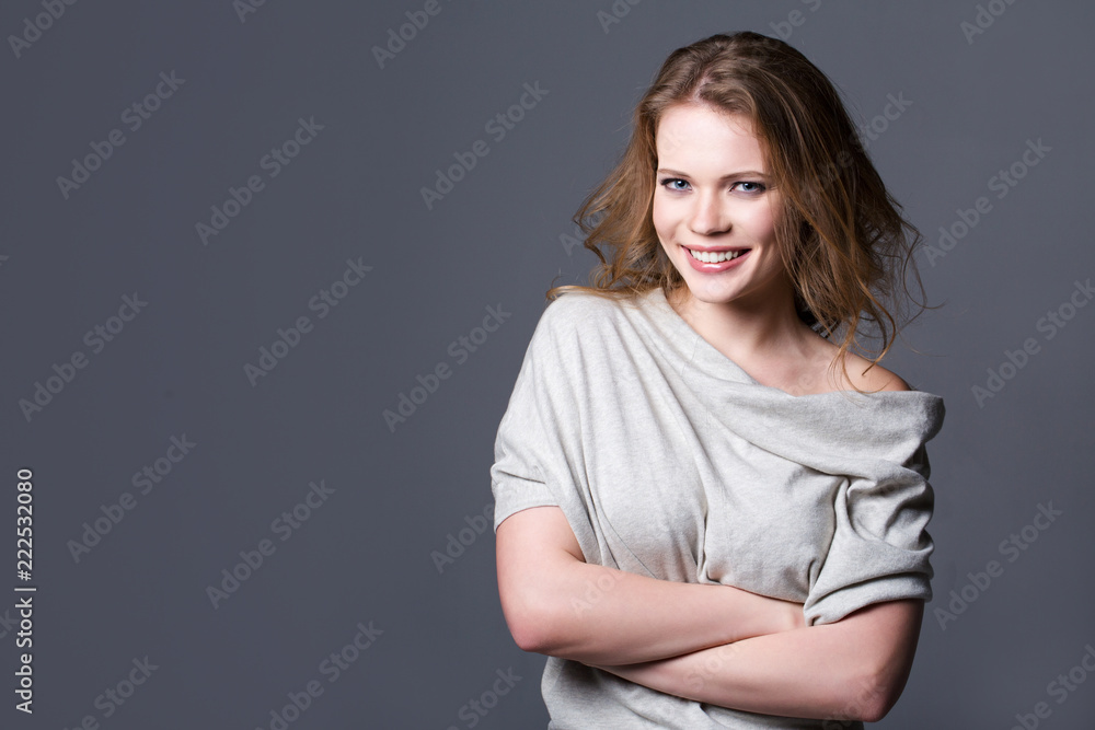 Woman smiling and posing with her hands crossed. Woman smiling and posing with her hands crossed.