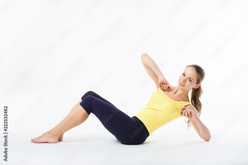 Woman exercising photographed in the white background. Woman exercising photographed in the white background.