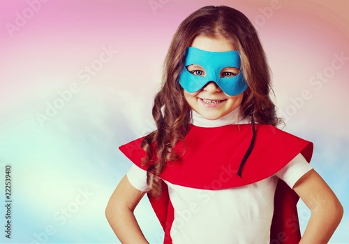 Portrait of beautiful little girl in superhero