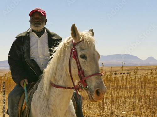 Fotografie Old Basotho man on horse In the African Kingdom of Lesotho