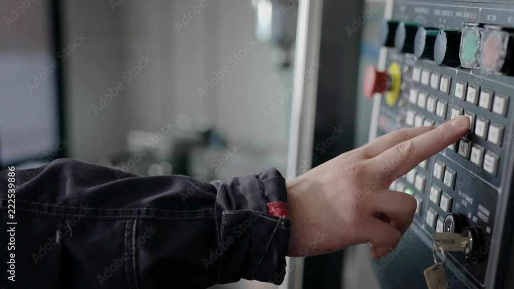Industrial machinery mechanics and factory worker adjusts the control