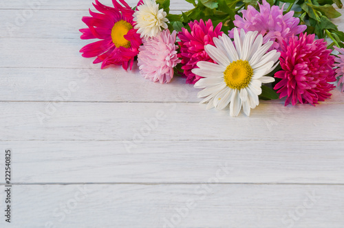 Bouquet of aster on a white wooden table