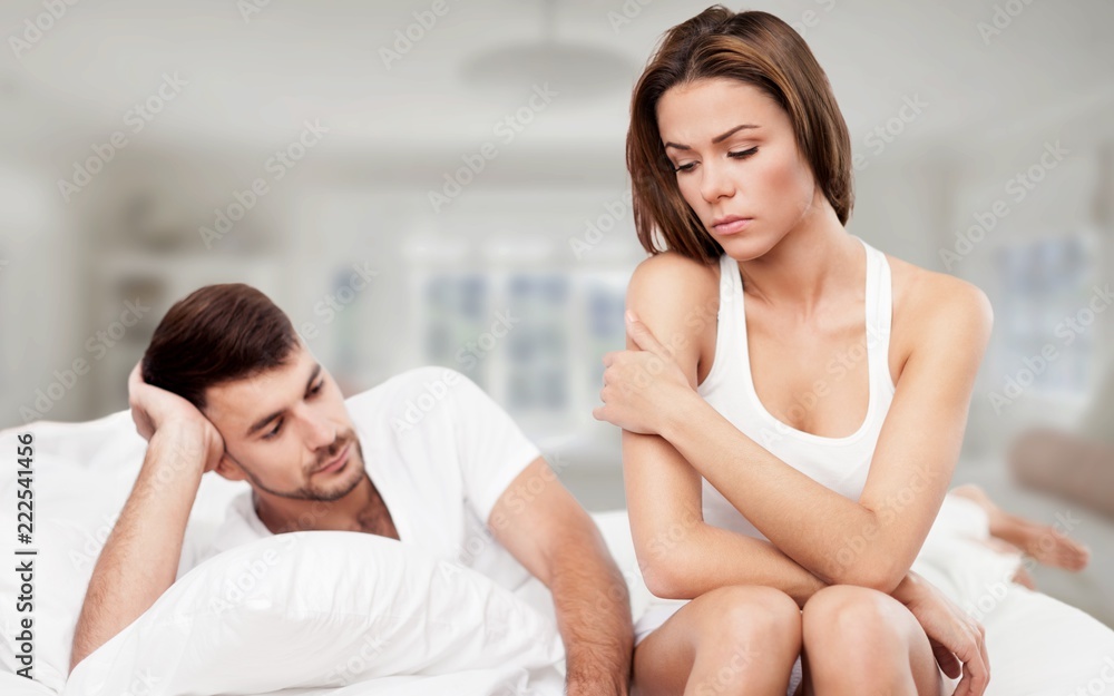 Fototapeta premium Dissatisfied beautiful young woman in bed with sad expression on