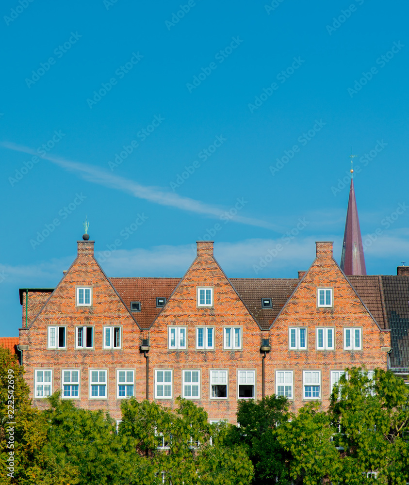 View at Catholic church spire and old brick houses in Bremen, Germany