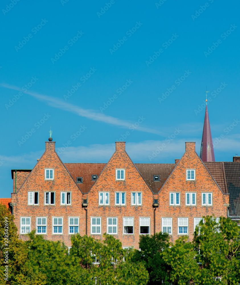 View at Catholic church spire and old brick houses in Bremen, Germany View at Catholic church spire and old brick houses in Bremen, Germany