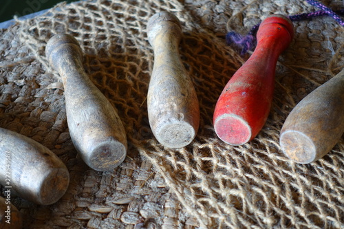 Принти на полотні Old wooden skittles, played in medieval times, on a rough hessian backdrop