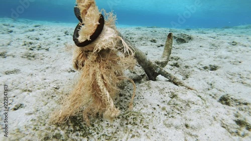 Underwater Shot Of An Old Boat Anchor At The End Of A Rope Laying On The Seabed