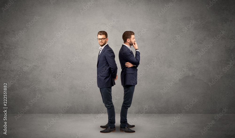 Young conflicted businessman choosing between two directions Young conflicted businessman choosing between two directions