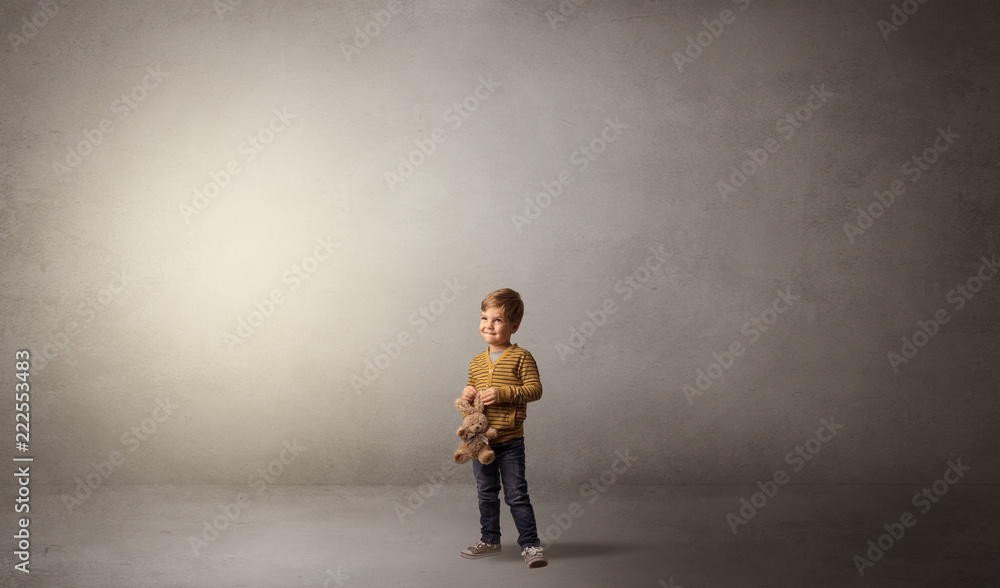 Little waggish kid staying alone in a big empty room with his plush
Little waggish kid staying alone in a big empty room with his plush