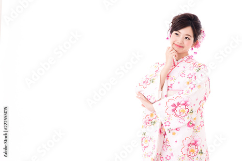portrait of young asian woman wearing pink kimono on white background © taka