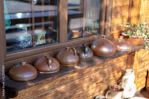 Old vases and water jugs. Home accessories from the last century set on the windowsill.