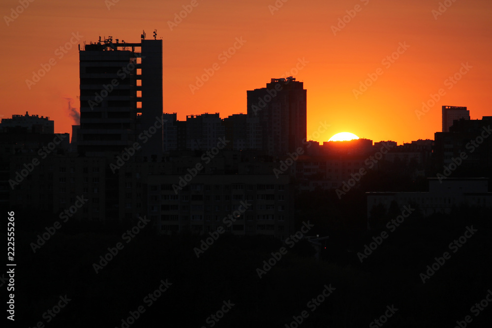 Cityscape with silhouette of city skyline against setting sun. Minsk, Belarus