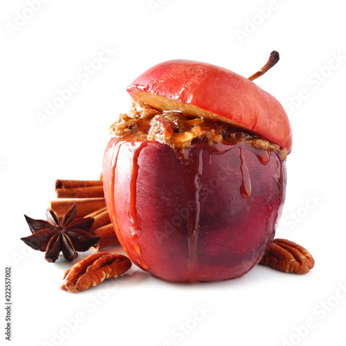 Baked apple with caramel, brown sugar, spices and and nuts isolated on a white background