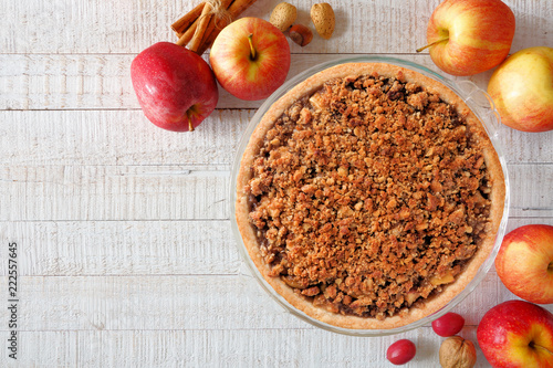 Slika na platnu Apple crumble pie, overhead scene on a white wood background