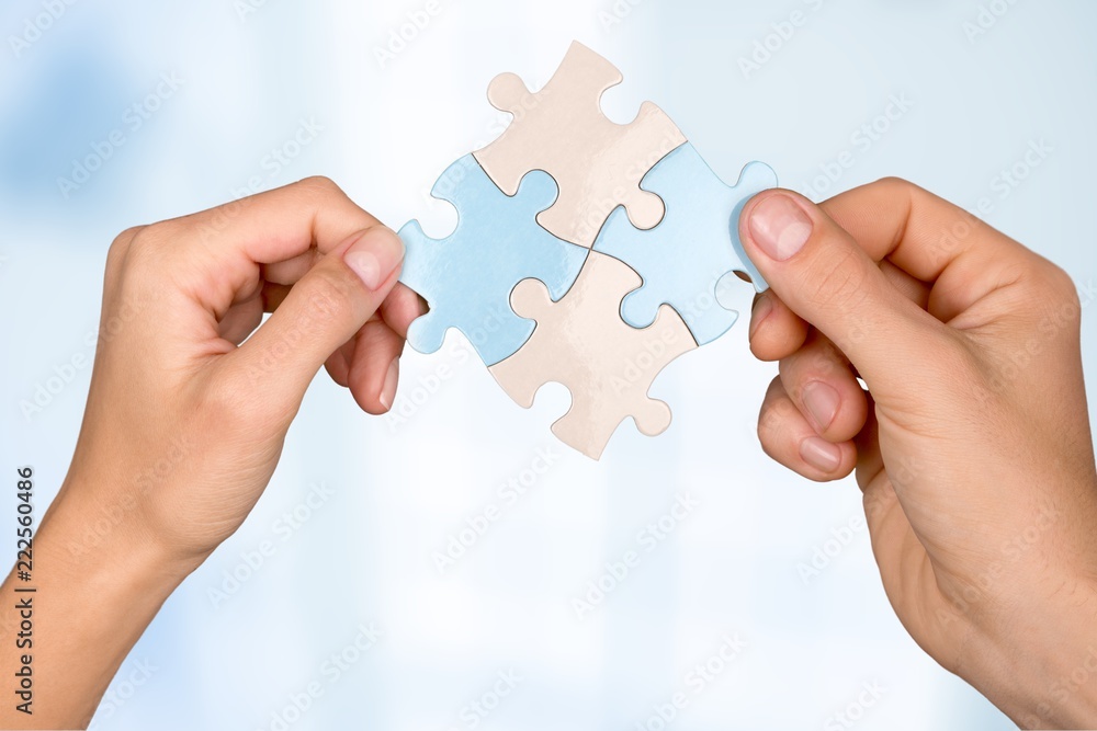 Human hands joining puzzle parts on background Human hands joining puzzle parts on background
