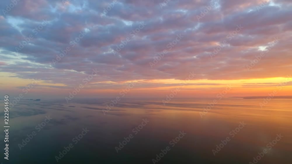 Amazing dawn sky over bay of tranquil waters, aerial view.
Amazing dawn sky over bay of tranquil waters, aerial view.