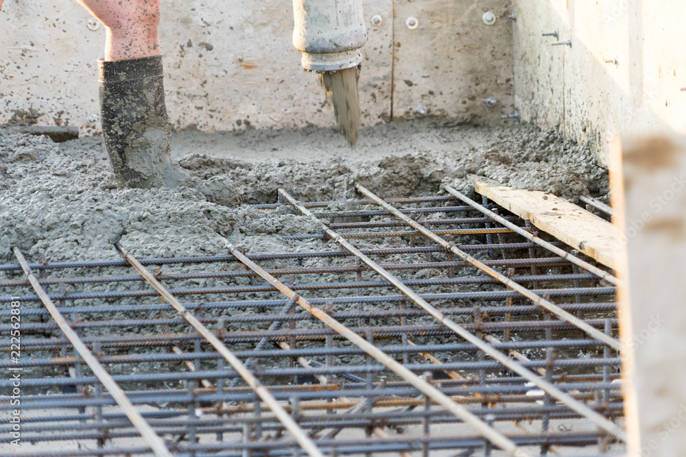 Workers pour the Foundation for the construction of a residential building. Workers pour the Foundation for the construction of a residential building.