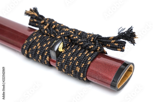 Sageo cord for tie the scabbard of Japanese sword and copper fitting isolated in white background.   photo