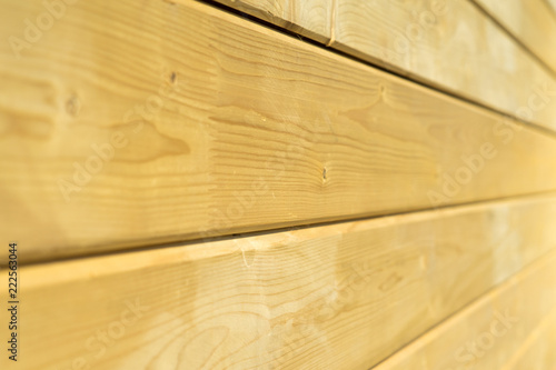 Photo wall of a wooden house made of wooden beams.