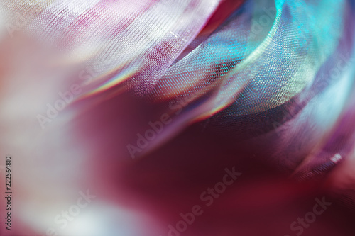 Blurry extreme close up macro of chiffon fabric. Beautiful sensual shapes colorful background. Real optical bokeh effect. Soft, delicate gentle pastel colors. Elegant decorative mesh textile backdrop photo