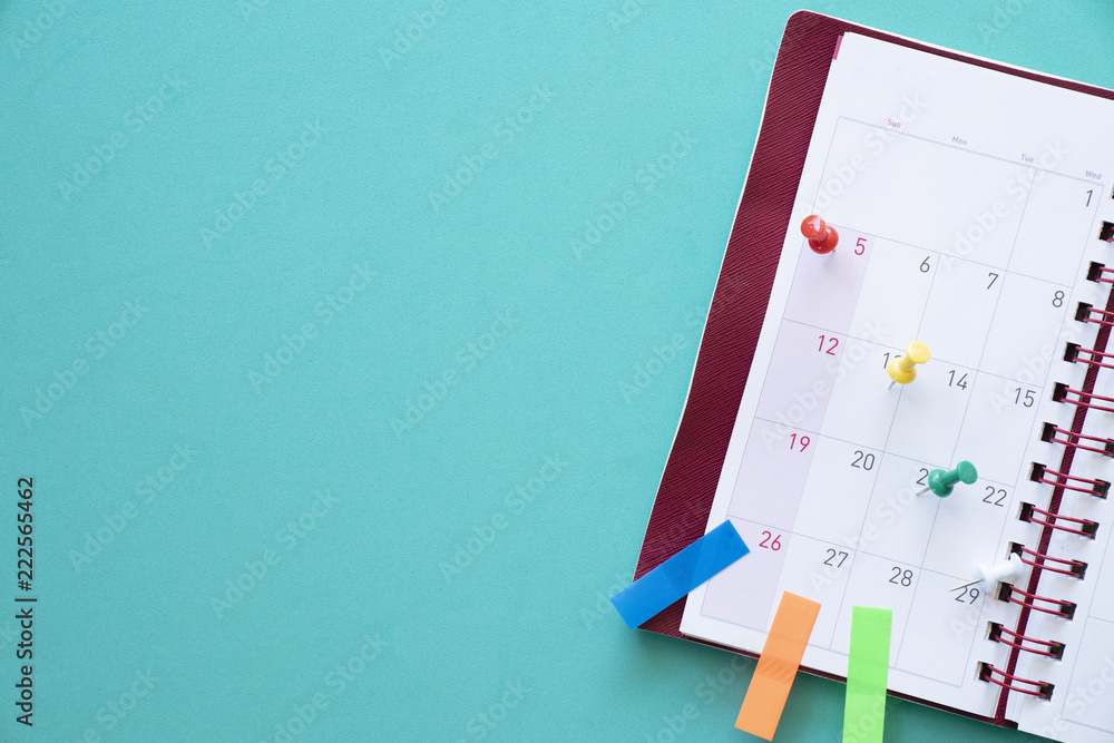 close up of calendar, planner on the green table, planning for business meeting or travel planning concept