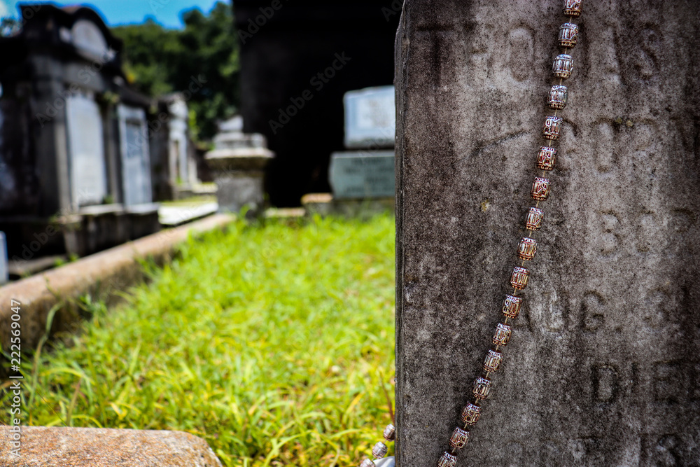 General angled view of old antique cemetery with raised crumbling sepulchers and blue skies General angled view of old antique cemetery with raised crumbling sepulchers and blue skies
