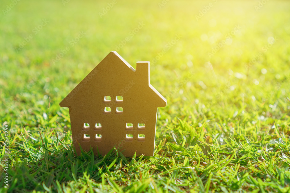 Closed up tiny home model on green grass with sunlight background. Closed up tiny home model on green grass with sunlight background.