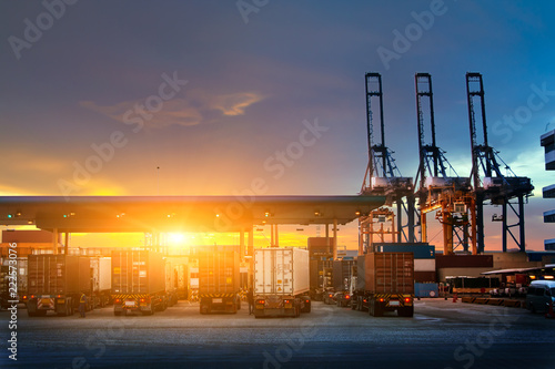 Industrial logistics and transportation of truck in Container yard for logistic and Cargo business plane at sunset