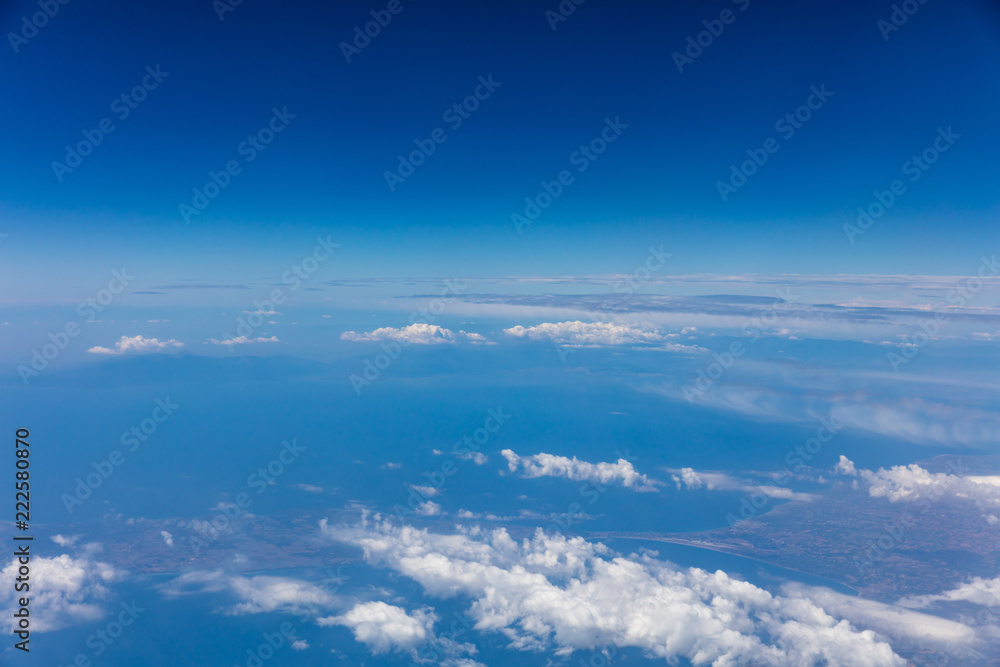 Cloudscape background. View out of an airplane window. Cloudscape background. View out of an airplane window.