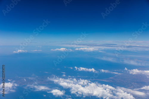 Cloudscape background. View out of an airplane window. © Rawf8