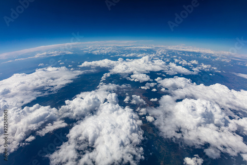 Curvature of planet earth. Aerial shot. Blue sky and clouds