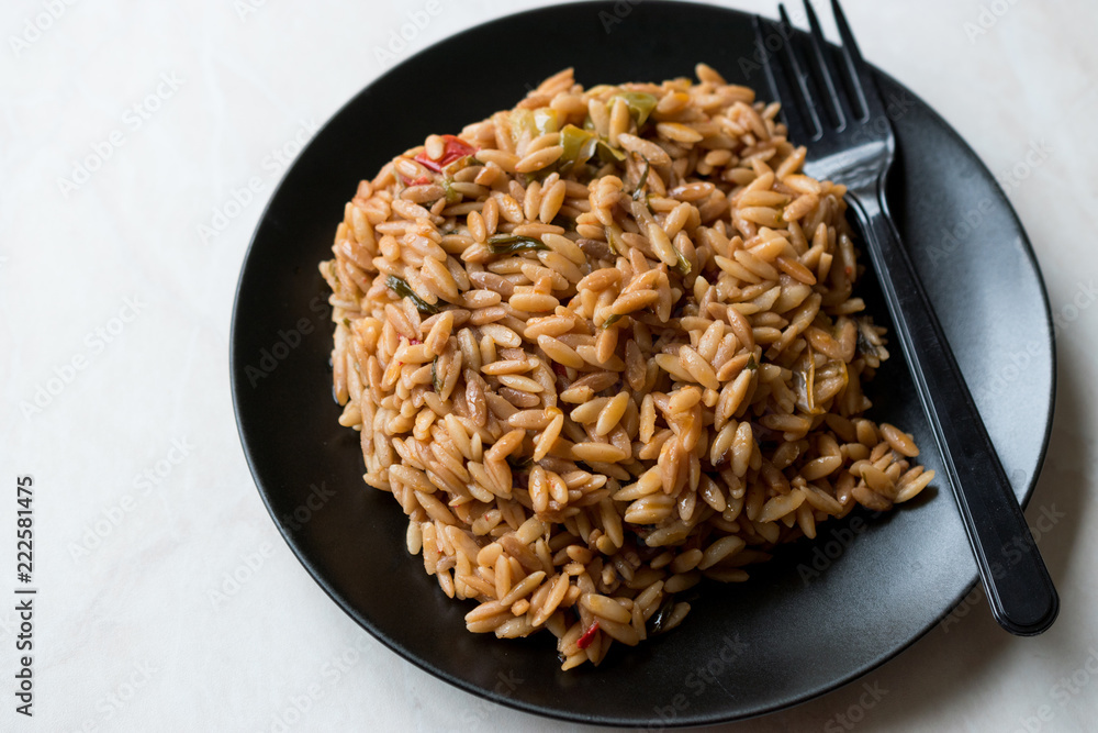 Turkish Style Cooked Orzo Pasta in Black Plate / Pilav or Pilaf. Turkish Style Cooked Orzo Pasta in Black Plate / Pilav or Pilaf.