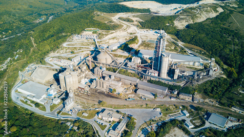 Aerial view of cement manufacturing plant. Concept of buildings at the factory, steel pipes, giants.