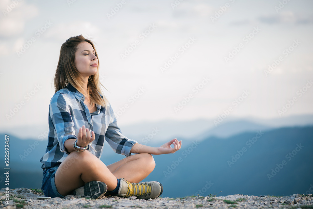 Young woman doing yoga in nature