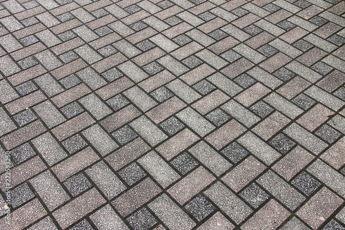 Texture: light street paving slabs of rectangular shape, gray and red.