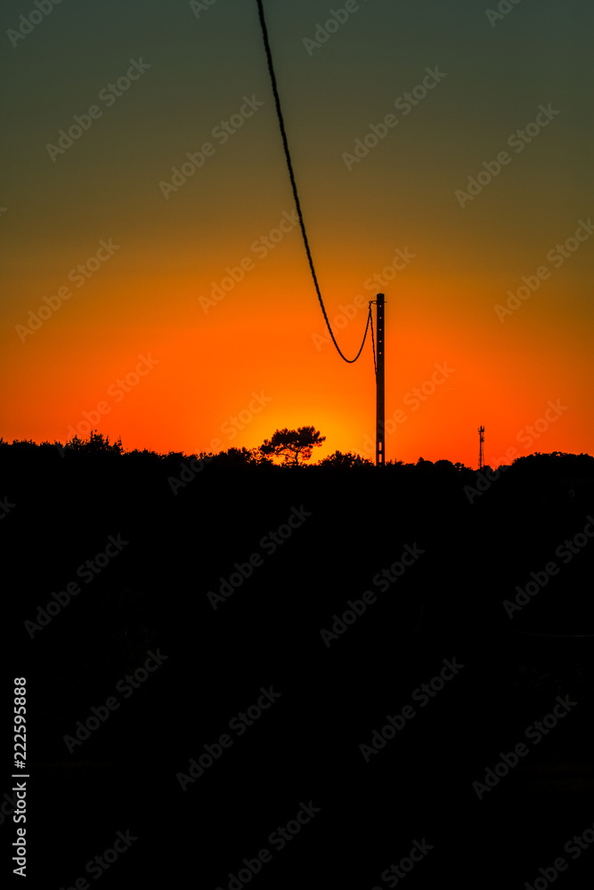 Obraz premium sunset with red sky and black foreground