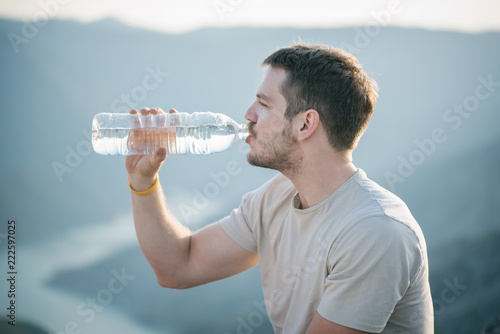 Young man drinking water