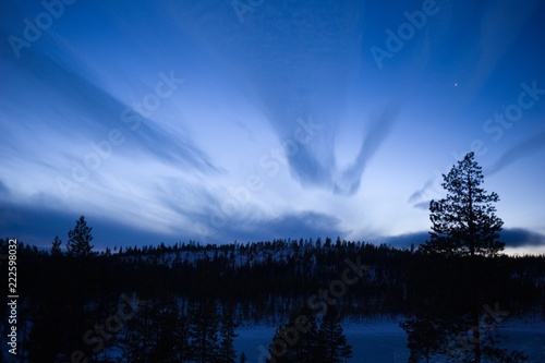 Twilight winter landscape. Stars appear in the sky.