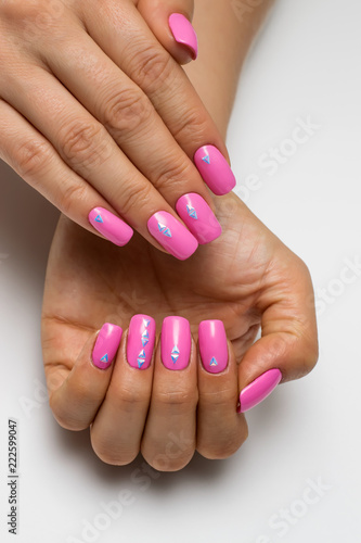 summer pink manicure with triangles, crystals, silver on short square nails on a white background