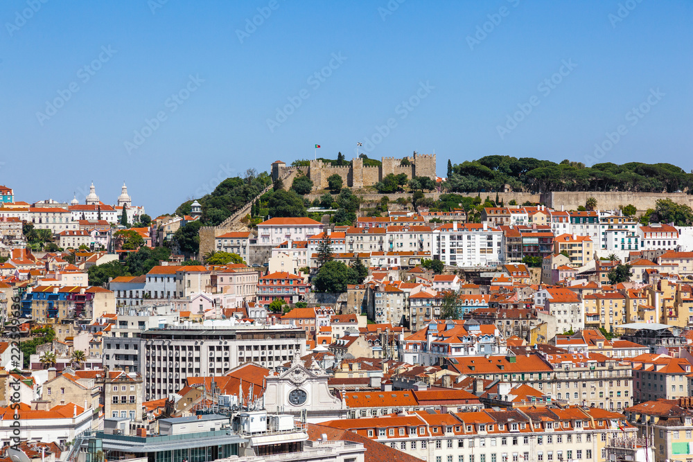 Lisbon, Portugal. View of the Castelo de Sao Jorge Castle aka Saint or St. George Castle, the Baixa, Alfama and Mouraria Districts. Typical Portuguese orange rooftops.