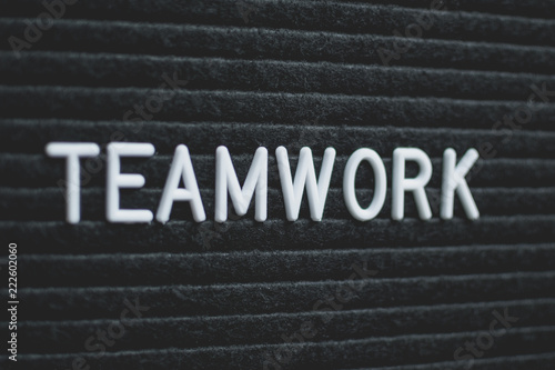 Word teamwork written on the letter board. White letters on the black background. Business concept