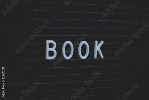 Word book written on the letter board. White letters on the black background. Business concept