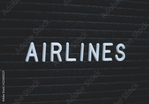 Word airlines written on the letter board. White letters on the black background. Business concept