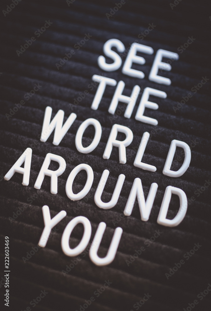 Fototapeta premium Phrase see the world around you written on the letter board. White letters on the black background. Business concept