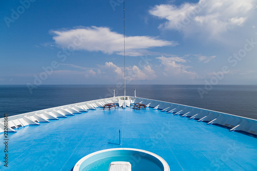 Front of cruise ship deck over looking ocean horizon