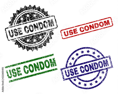 USE CONDOM seal prints with damaged surface. Black, green,red,blue vector rubber prints of USE CONDOM text with retro surface. Rubber seals with round, rectangle, rosette shapes.