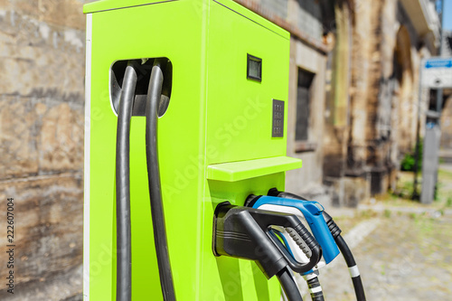 Wallpaper Mural electric vehicle charging and filling station with plug of power cable supply for Ev cars, eco friendly modern business startup concept Torontodigital.ca