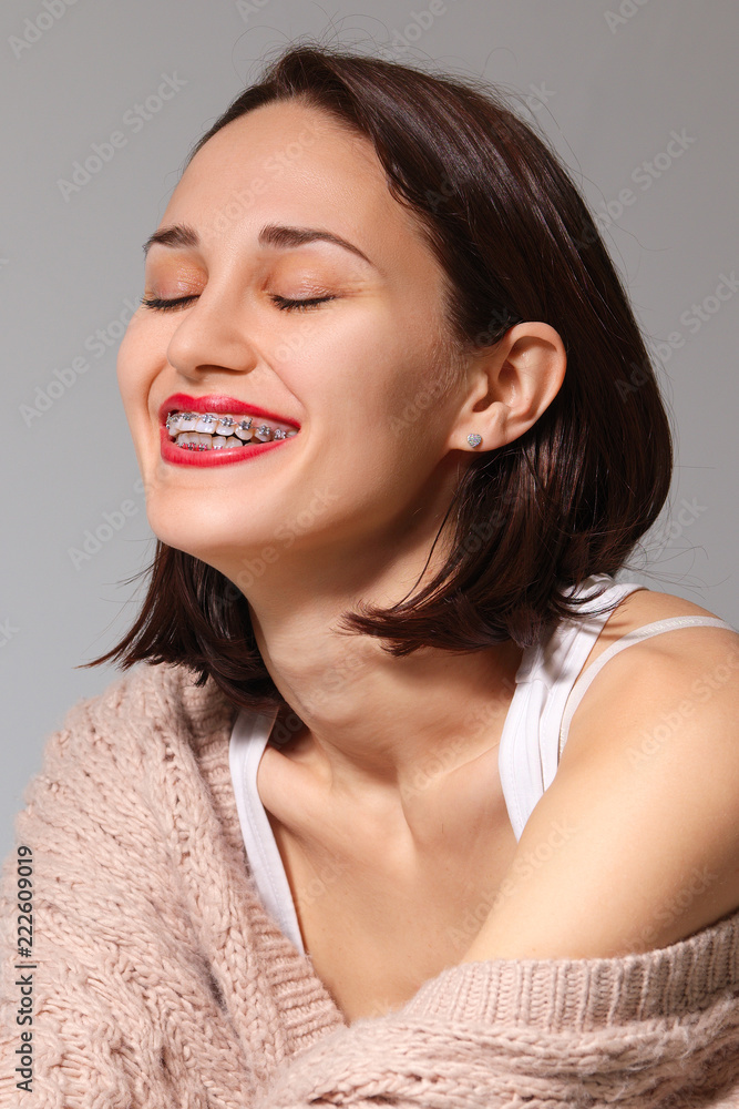 Happy smiling lady showing her teeth with braces Happy smiling lady showing her teeth with braces