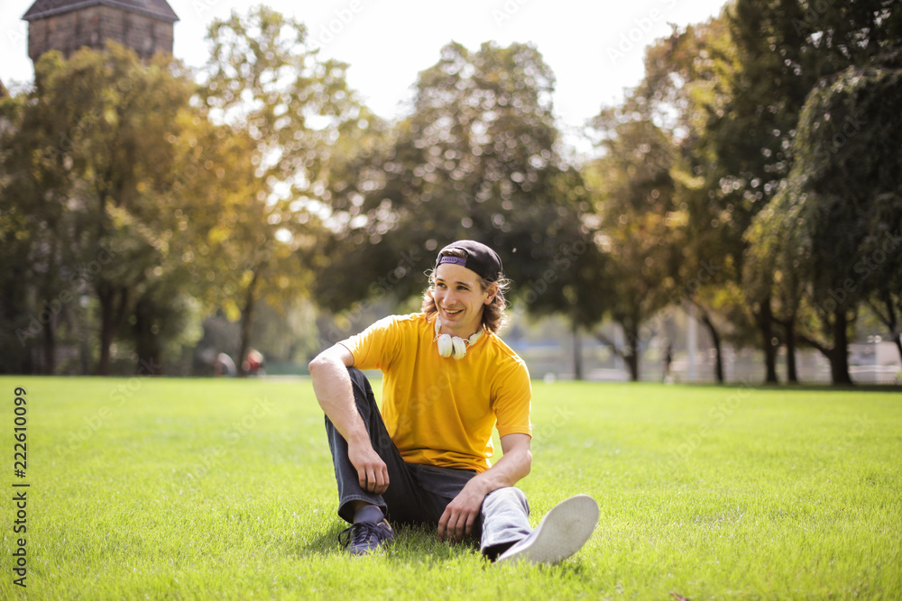 Young man hanging out in a park. Young man hanging out in a park.